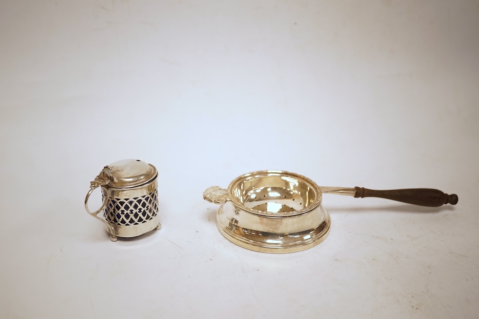 A small quantity of assorted silver including a Victorian sauceboat, London, 1851, length 12.6cm, a sugar bowl, a tea strainer on stand, mustard pot and ladle, three mounted brushes, a salt, pieced bonbon dish and a case